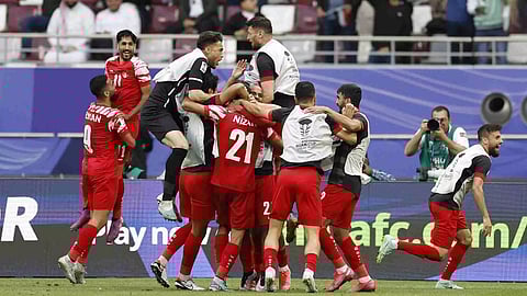  Jordan's Nizar Al Rashdan celebrates scoring their third goal with teammates (Photo/Reuters)
