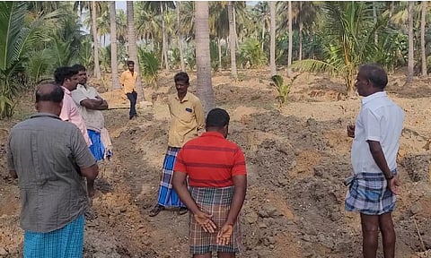 Farmers looking at the land from which the wires were stolen near Gudiyattam