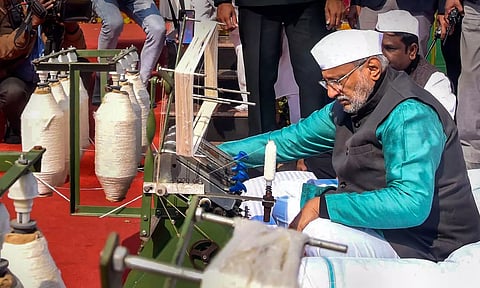 Jharkhand Governor CP Radhakrishnan operates a spinning wheel (Charkha) after offering tribute to Mahatma Gandhi on Martyrs Day at Bapu Vatika in Ranchi. (PTI)