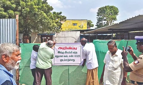 Officials stick notice on the closed Tasmac outlet in Perambalur on Wednesday