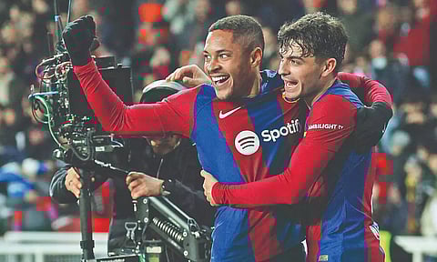 Vitor Roque (L) celebrates his first goal for Barcelona with Pedri