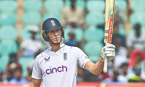 Zak Crawley raises his bat after scoring half-century
