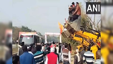 People shower flowers on bus of MLAs visiting Ayodhya. (Photo/ANI)