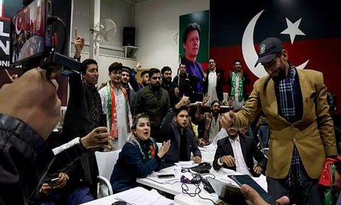 PTI supporters watch the general election results at a PTI officein Islamabad (ANI)