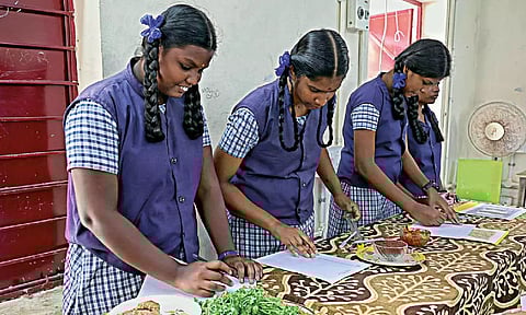 Class 12 students of a school in city attending the practical exams that began across the State on Monday
