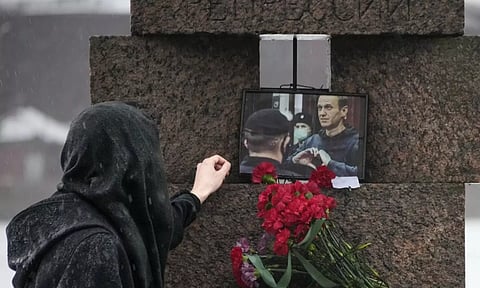 A person paying tribute to Alexei Navalny. AP