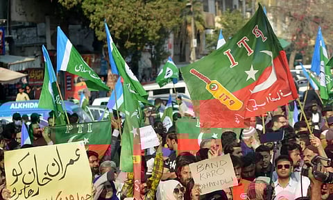 Supporters of the Pakistan Tehreek-e-Insaf (PTI) protest outside an election commission office in Karachi (AFP)