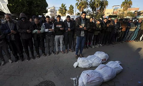 Palestinians pray for the relatives killed in the Israeli bombing in the Gaza Strip at Al Aqsa Hospital in Deir al Balah, Gaza Strip on Saturday. (AP)