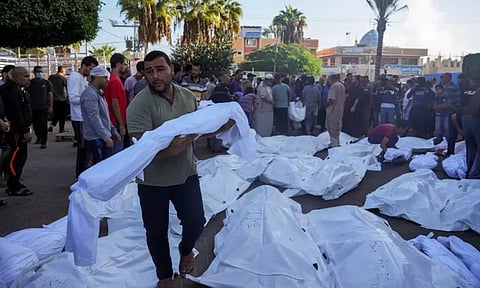 Palestinians mourn relatives killed in the Israeli bombardment of the Gaza Strip in front of the morgue in Deir el-Balah on November 6, 2023 (AP)