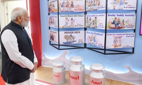 : Prime Minister Narendra Modi inspects an exhibition by Amul at Ahmedabad (IANS)