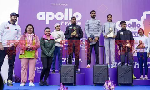 Union Minister of State Meenakshi Lekhi, former cricketer Irfan Pathan, and Bollywood actor Soha Ali with New Delhi Marathon 2024 winners during the presentation ceremony at Jawaharlal Nehru Stadium in New Delhi on Sunday (PTI)