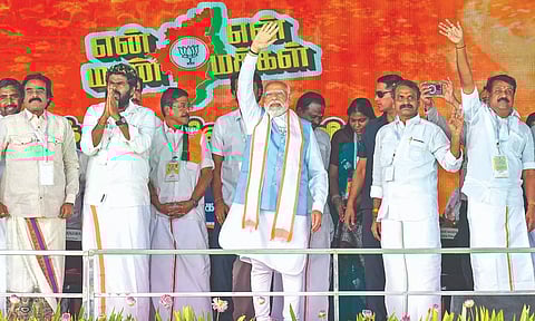 PM Narendra Modi with State BJP president K Annamalai and Union MoS L Murugan during the closing ceremony of BJP’s ‘En Mann Ek Makkal’ padyatra, near Palladam in Tirupur on Tuesday