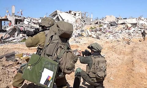 Israeli soldiers operate amid the ruins of buildings at Gaza Strip (REUTERS)