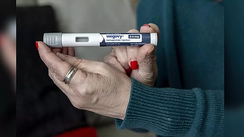 Donna Cooper holds up a dosage of Wegovy, a drug used for weight loss (AP)