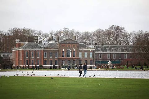 People walk through Kensington Gardens with Kensington Palace in the background, in London (Reuters)