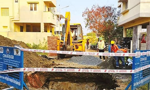 Workers from the Metro Water board at the site in Semmencheri on Monday