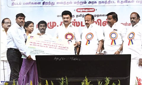 Chief Minister MK Stalin handing over a cheque to the beneficiary of a government scheme on Monday