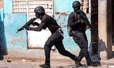 Police officers take part in an operation on the surroundings of the National Penitentiary following a fire (Reuters)