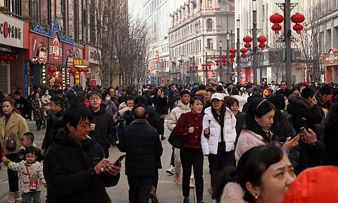  Visitors throng a pedestrian shopping street on the first day of the Lunar New Year of the Dragon (Reuters)