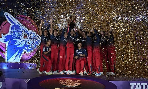 Royal Challengers Bangalore players celebrate with the trophy after winning the WPL-T20 fina