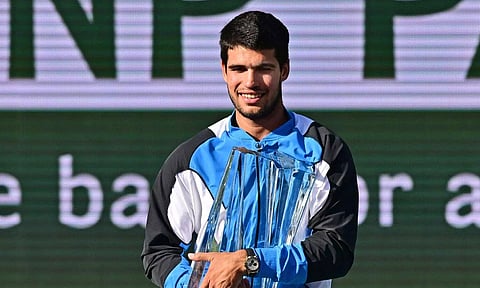 Carlos Alcaraz poses with trophy