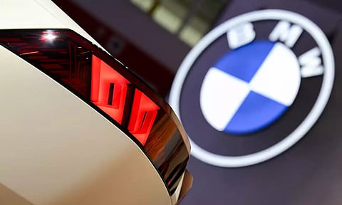 A BMW Vision Neue Klasse is displayed next to the company's logo