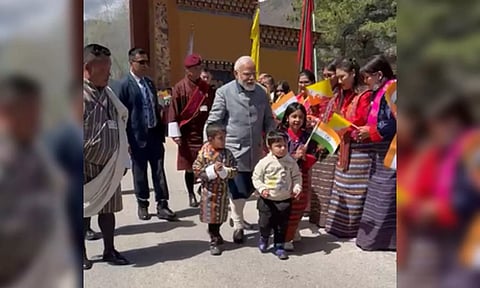 PM Modi walking with children along the streets of Bhutan (IANS)