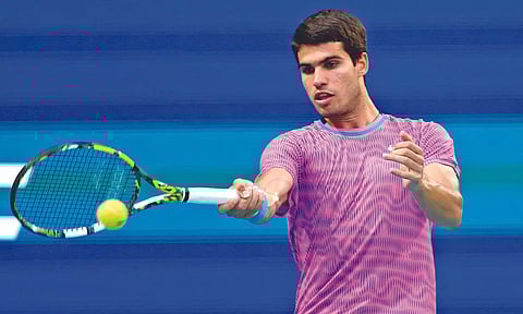 Carlos Alcaraz returns a shot in his match against Lorenzo Musetti