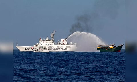 Chinese Coast Guard vessels fire water cannons towards a Philippine resupply vessel Unaizah in South China Sea (Reuters)