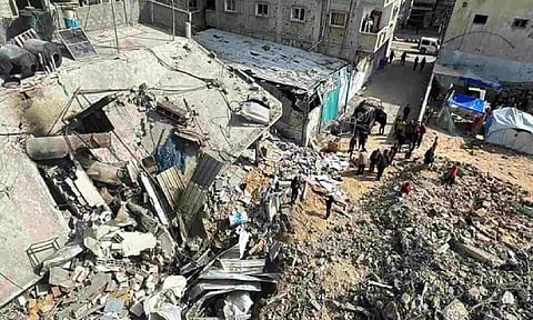 Palestinians inspect the site of an Israeli strike, in Rafah, in the southern Gaza Strip (Reuters)