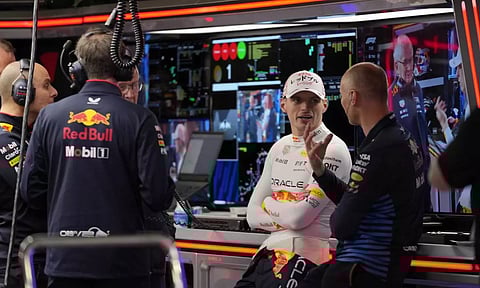 Max Verstappen chats with team members in the garage (AP)