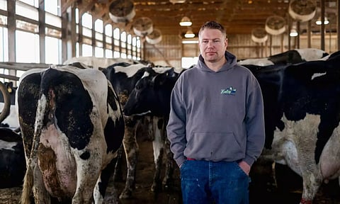 Dairy farmer Brent Pollard stands for a portrait inside of a cow pen at his farm in Rockford (Reuters)