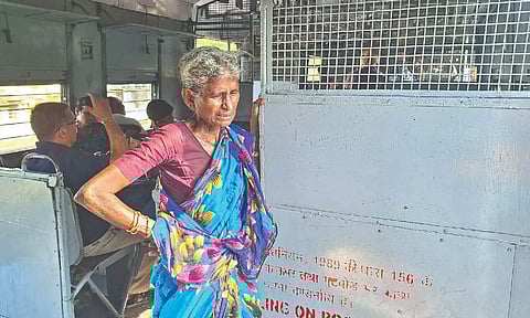 An elderly women inside the train