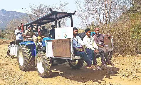 For the first time, polling personnel taking election materials on a tractor, instead of donkeys, to hill villages in Dharmapuri district on Thursday