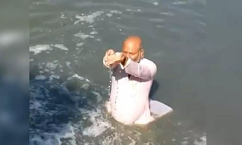 Ujjain lok sabha seat candidate Mahesh Parmar sits in overflowing drain water entering the Shipra river (ANI)
