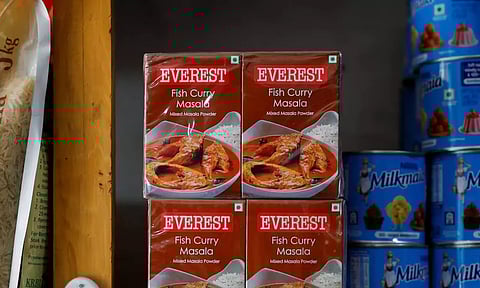 Boxes of Everest fish curry masala are stacked on the shelf of a shop at a market (Reuters) 