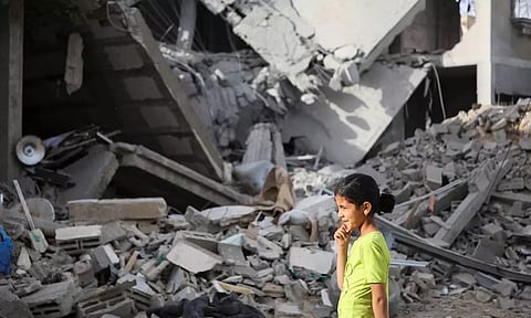  A Palestinian girl walks past the site of an Israeli strike on a house, in Rafah, in the southern Gaza Strip (REUTERS)