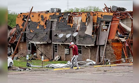 A man walks past a damaged building after it was hit by a tornado the night before in Sulphur, Oklahoma (Reuters)