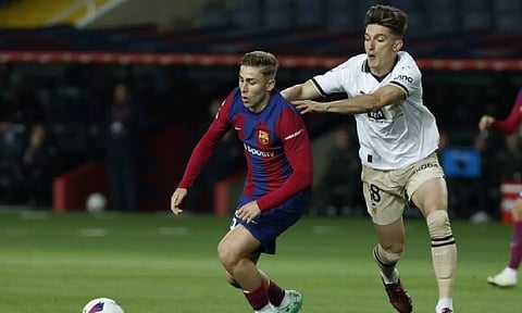 Barcelona's Ander Astralaga fights for the ball with Valencia's Pepelu (AP)