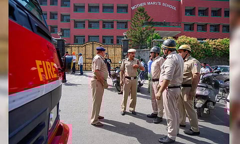 A police personnel exits the Mother Mary's School, Mayur Vihar after multiple schools received bomb threats via e-mail, in New Delhi (PTI)