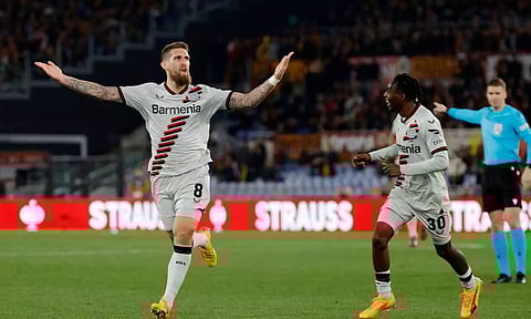 Leverkusen's Robert Andrich celebrates scoring their second goal with Jeremie Frimpong (Reuters)