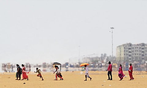 People walking at beach under hot sun (Photo: Justin George)