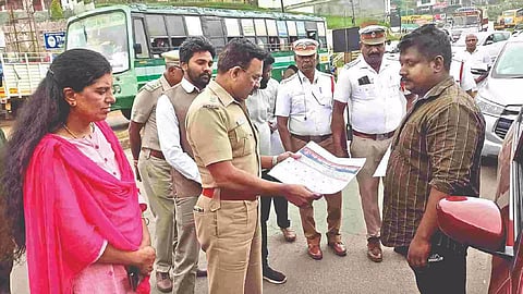 Superintendent of Police P Sundaravadivel distributing maps showing tourism spots to visitors in the Nilgiris district