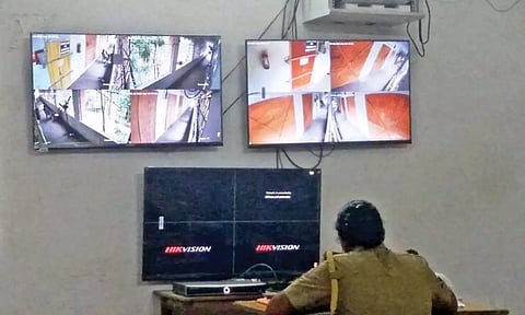 Police personnel starring at the blacked out screens of two CCTVs facing the EVM strongrooms in Villupuram on Wednesday