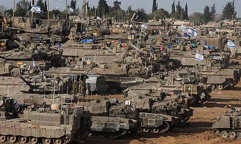 Israeli military vehicles are seen near the Israel-Gaza Border (Reuters)