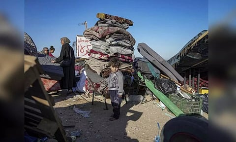 Displaced Palestinians arrive in central Gaza after fleeing from the southern Gaza city of Rafah in Deir al Balah, Gaza strip on Wednesday (AP)