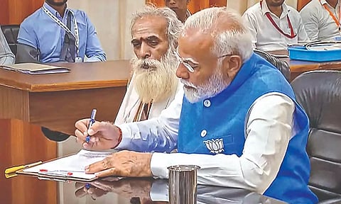 Prime Minister Narendra Modi with Pandit Ganeshwar Shastri while filing his nomination papers for Lok Sabha elections in Varanasi