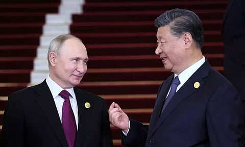 Russian President Vladimir Putin is welcomed by Chinese President Xi Jinping during a ceremony at the Belt and Road Forum (Reuters)