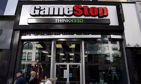 People walk by a GameStop in Manhattan (Reuters)