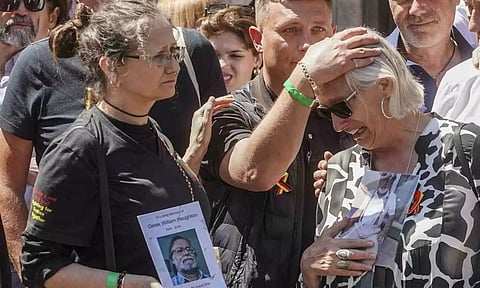 Cressida Haughton,lest,who's father Derek and Deborah Dennis who's father Dennis died,react outside Hall in Westminster in London, after the publication of the Infected Blood inquiry report (AP)